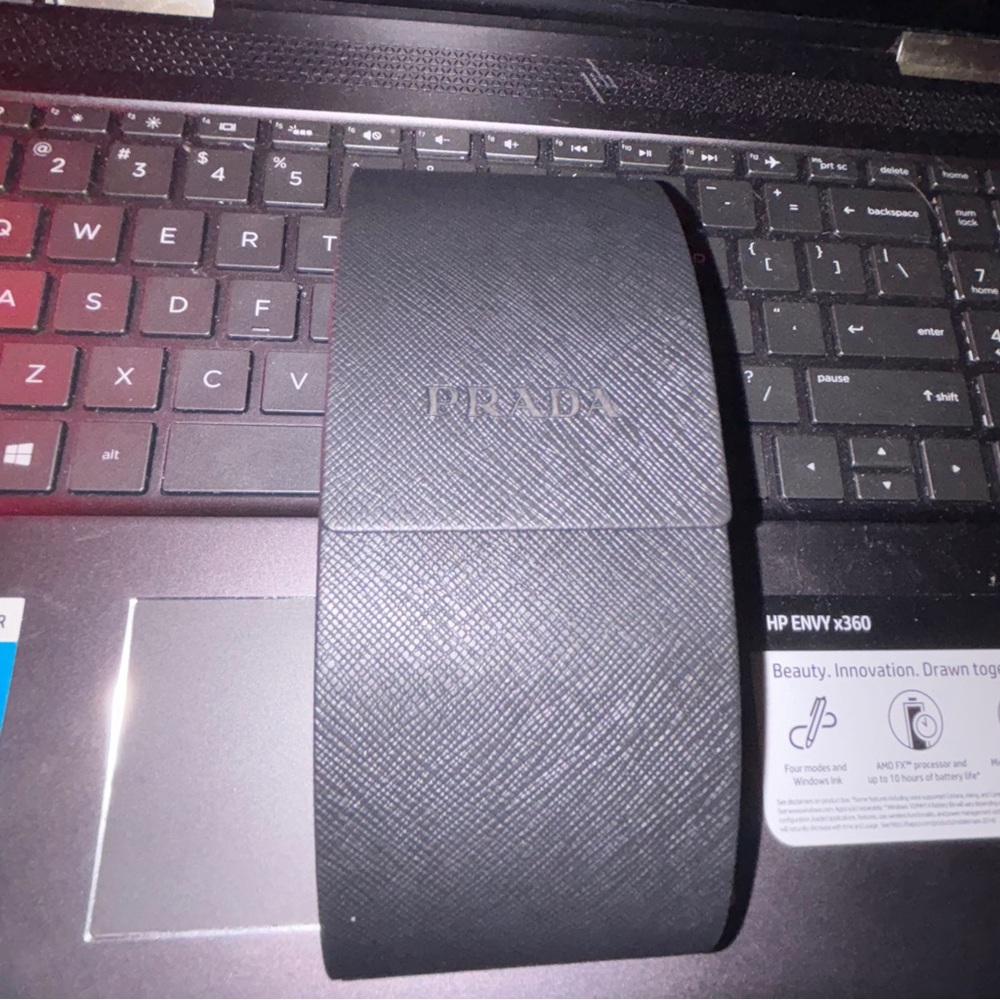 Authenticated Prada Sunglasses with triangle logo (serial number shown)